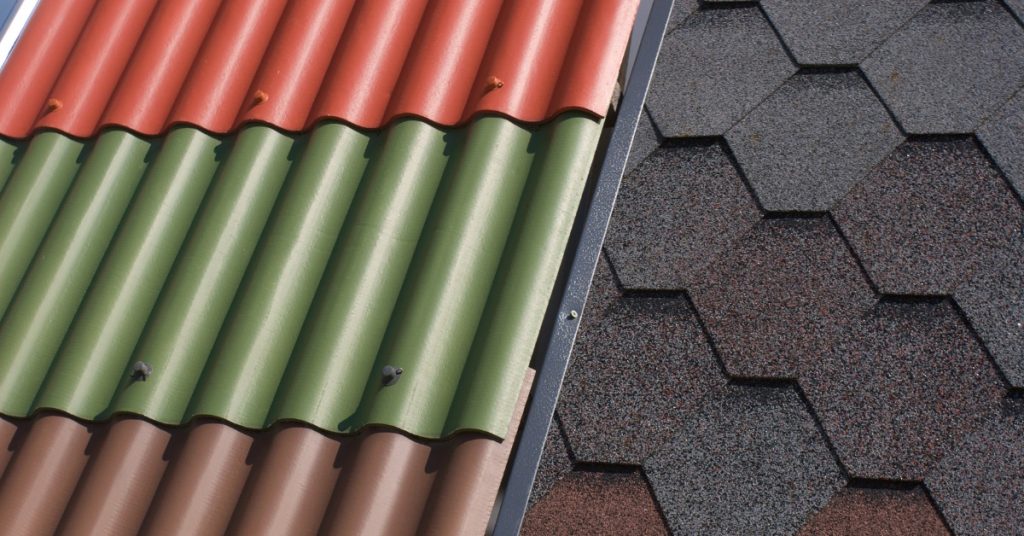 A roof split in two, the left side covered in metal shingles and the right side covered in asphalt hexagon shingles.